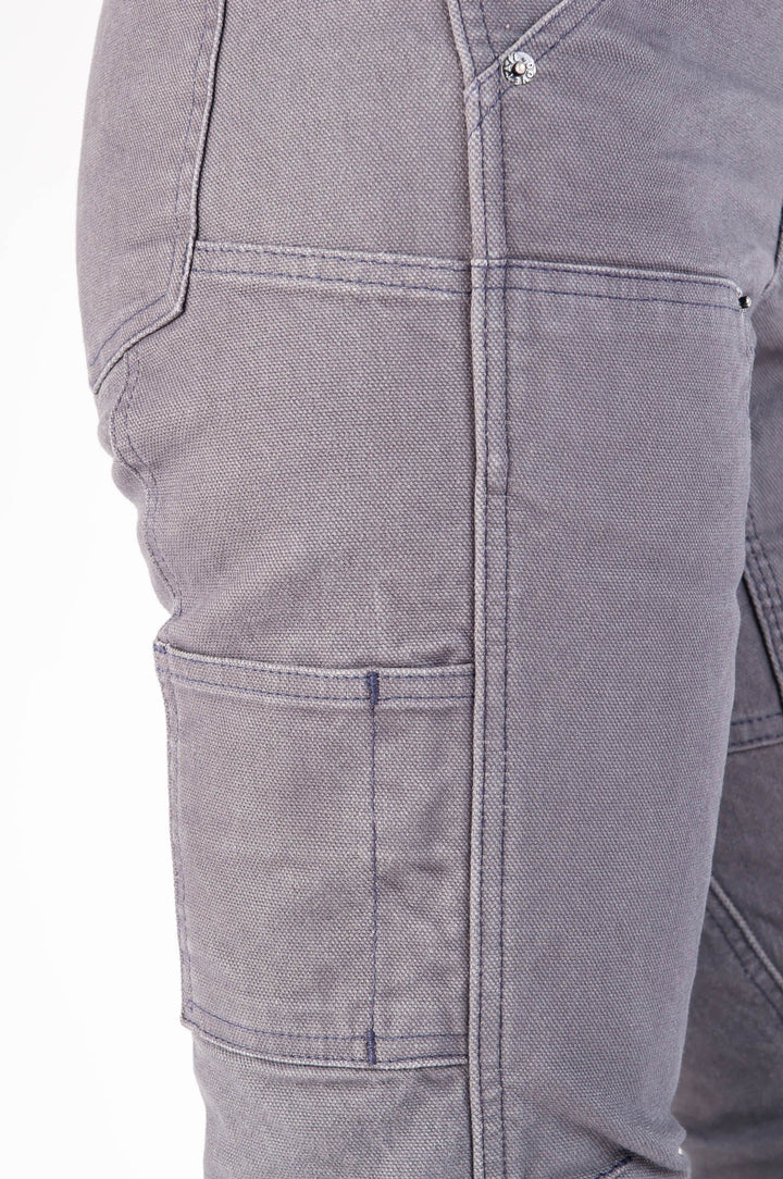 Close up of the right side panel pockets on the Britt Utility work pant for women in grey stretch canvas. There is a reinforced seam on the kneepanel. The two nesting pockets with a pencil holder, and corner of the back pocket are also shown. 